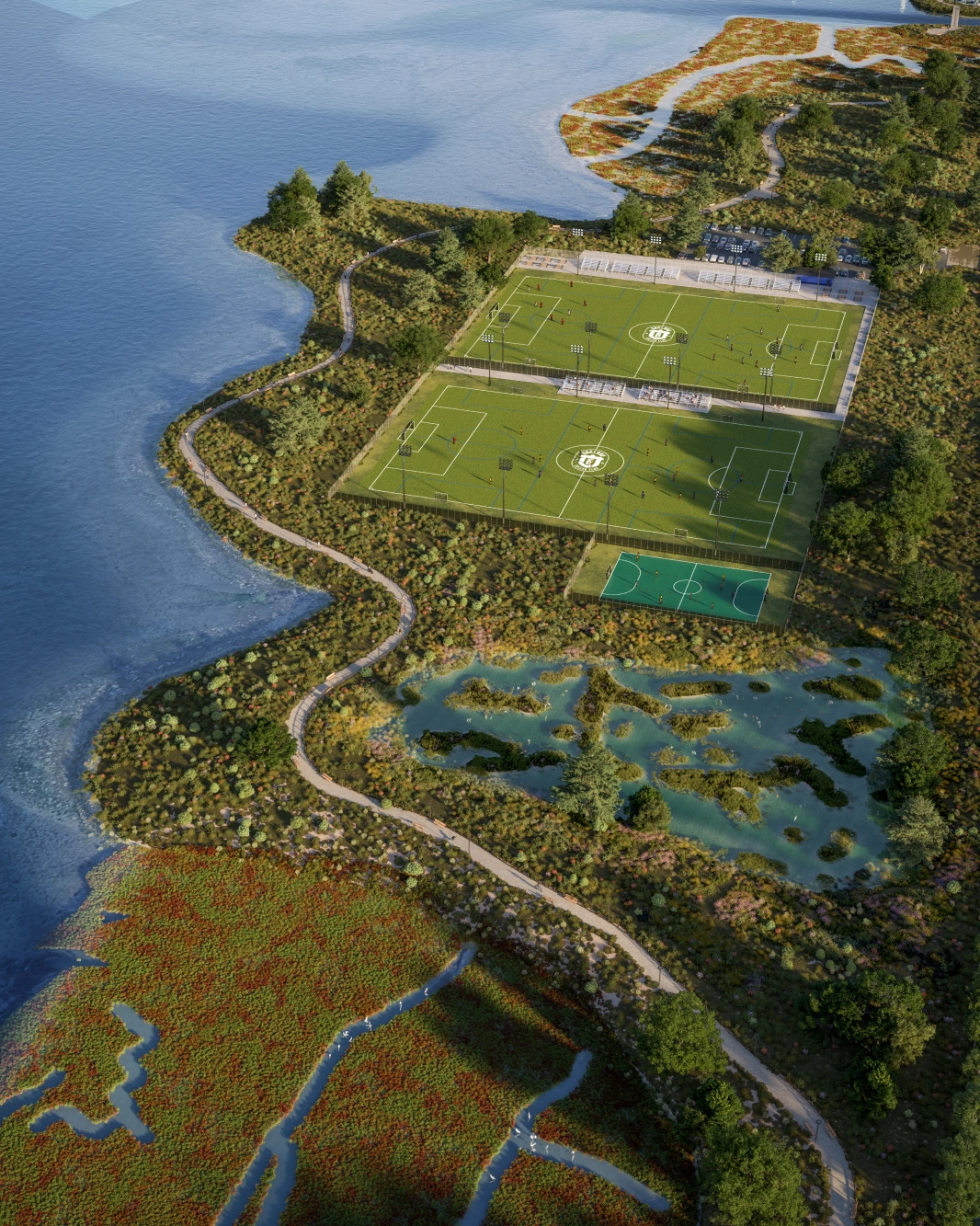 Scenic shoreline park featuring soccer pitches boardwalk path and restored wetlands