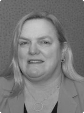 Professional black and white headshot of woman in business attire