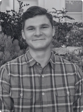 Black and white professional headshot of confident young businessman